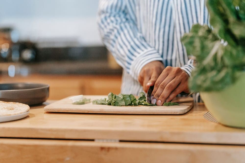 A wooden cutting board in use in a home kitchen