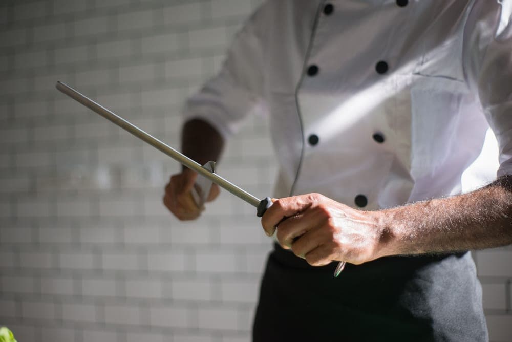 A honing rod held beside a kitchen knife