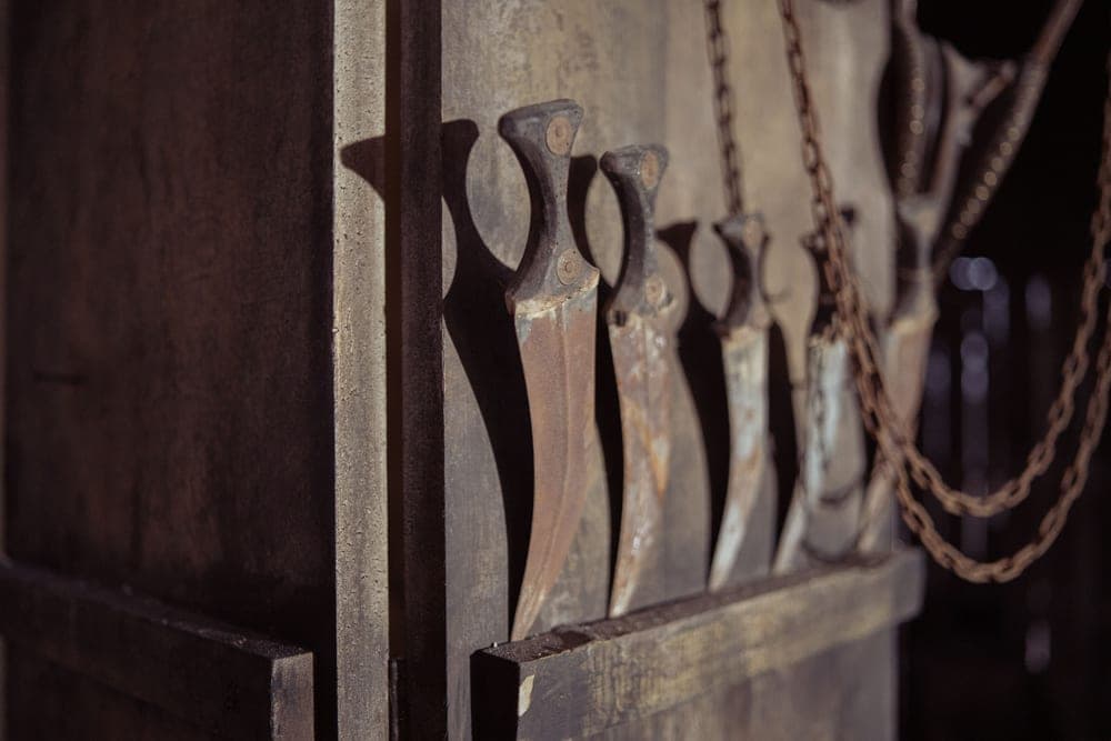 Old knives with corroded blades on a workshop surface