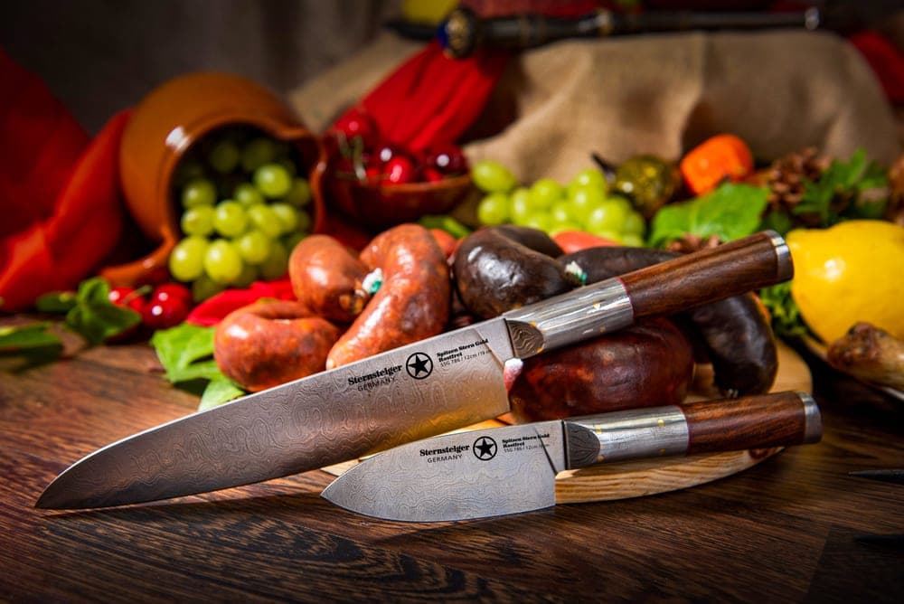 A group of kitchen knives arranged on a wooden surface