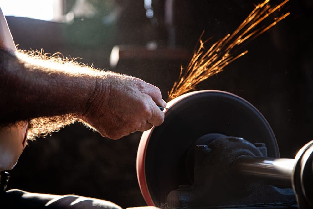 A blade being worked against an abrasive surface