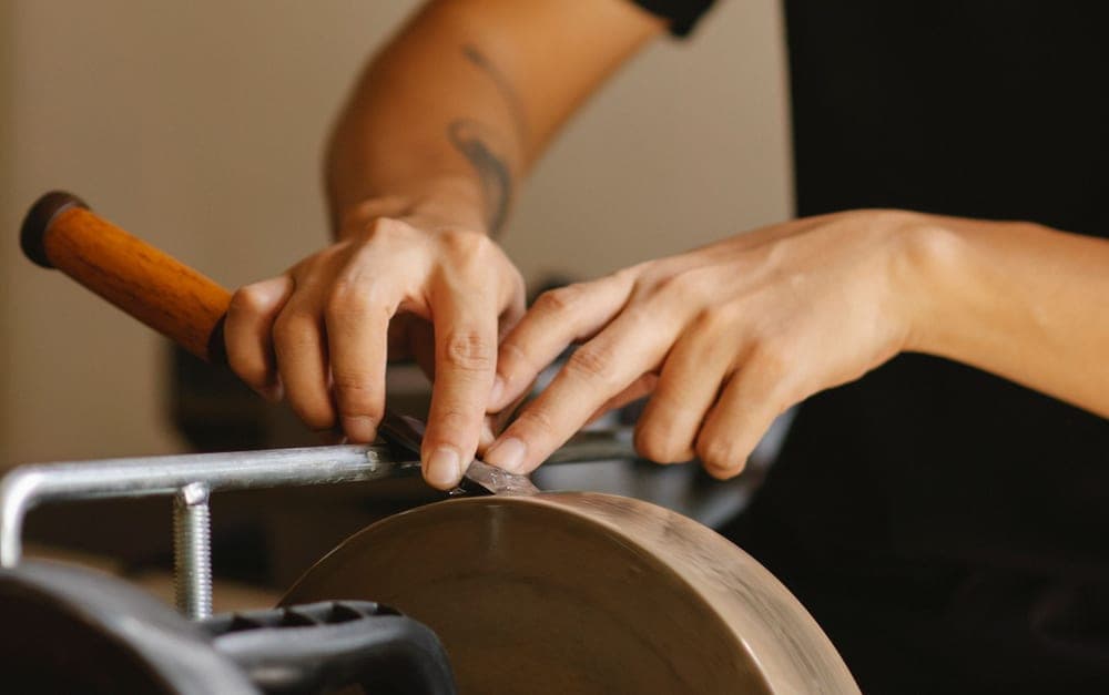 A sharpening stone set out on a workshop bench